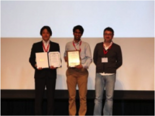 In the award ceremony (Left: Prof. Shibata, Middle: Mr. Koganti, Right: Presenter)